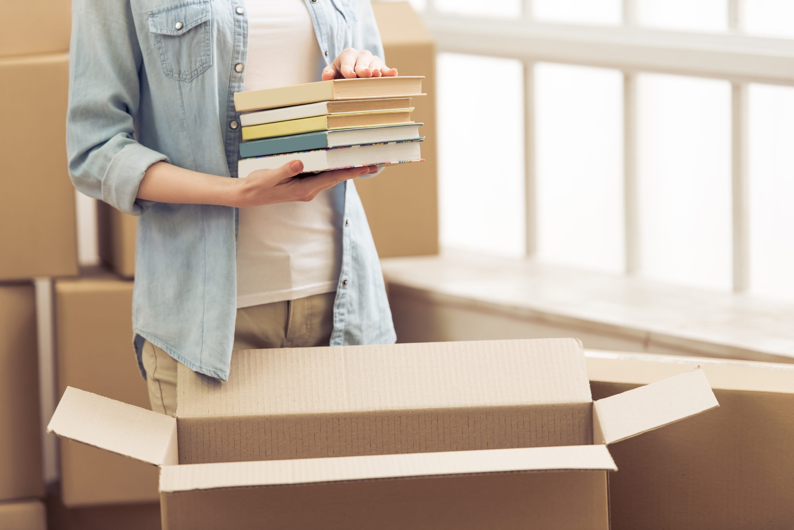 Person holding books with boxes